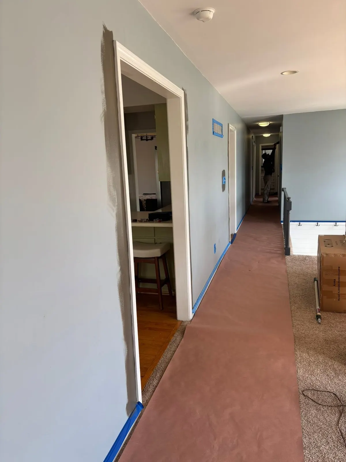 Hallway with fresh walls and protected floors