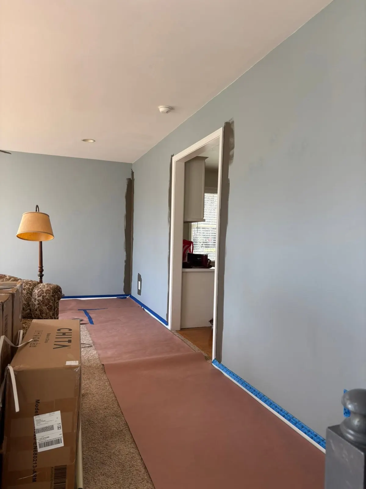 Hallway in progress with floors and trim protected